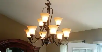 Classic ceiling chandelier installation with warm lighting in Birmingham, AL