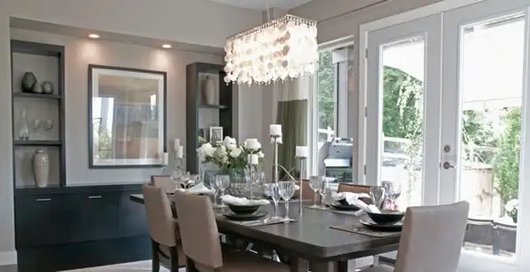 Elegant dining room chandelier installation above table in Birmingham, AL