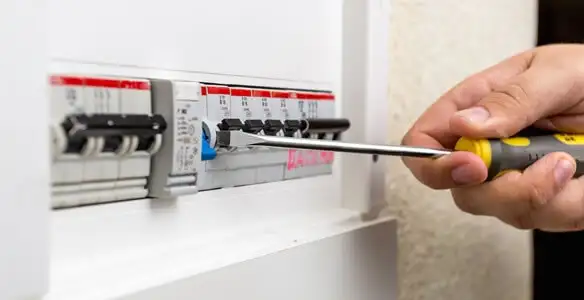 electrical panel upgrade service showing technician adjusting circuit breakers during system upgrade in Birmingham, AL