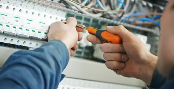 electrical service showing licensed electrician performing electrical panel maintenance and adjustments in Birmingham, AL