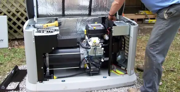 generator installation service showing technician connecting and configuring generator components in Birmingham, AL