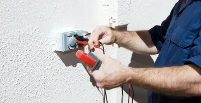 Electrician performing home electrical outlet and wiring inspection in Birmingham, AL