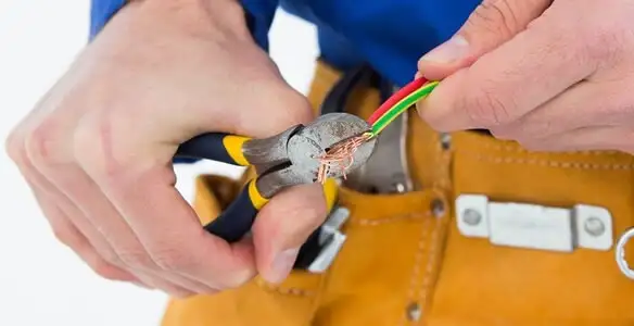 licensed electrician securing electrical wiring with professional tools during service work in Birmingham, AL