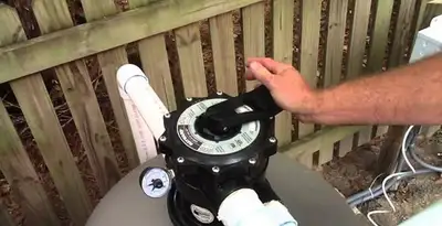 pool pumps service showing professional adjustment of pool pump control system in Birmingham, AL