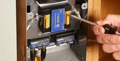 Whole home surge protection device being installed by a licensed electrician to protect electrical systems in Birmingham, AL